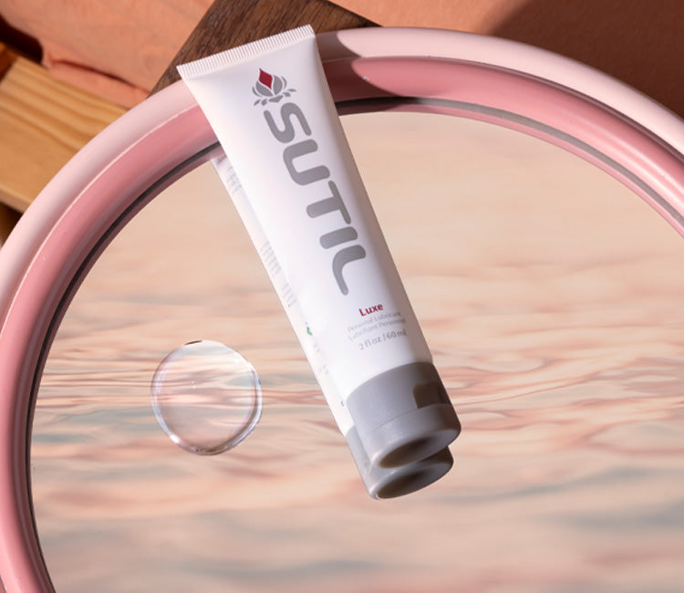 Sutil Luxe lube bottle displayed on a mirror